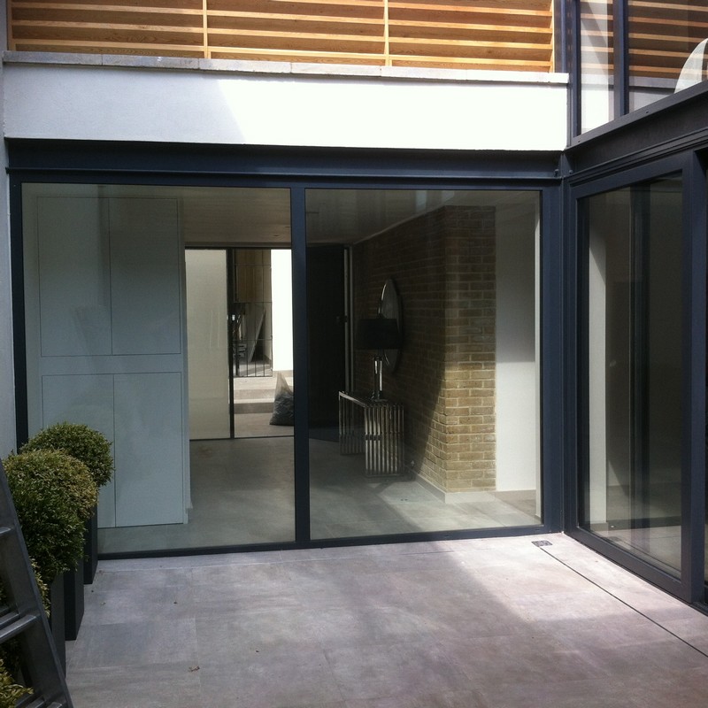 Floor-to-ceiling sliding doors opening to courtyard in New Cross Gate