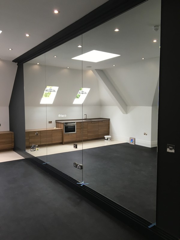 Frameless glass partition in loft conversion by New Cross Gate glaziers