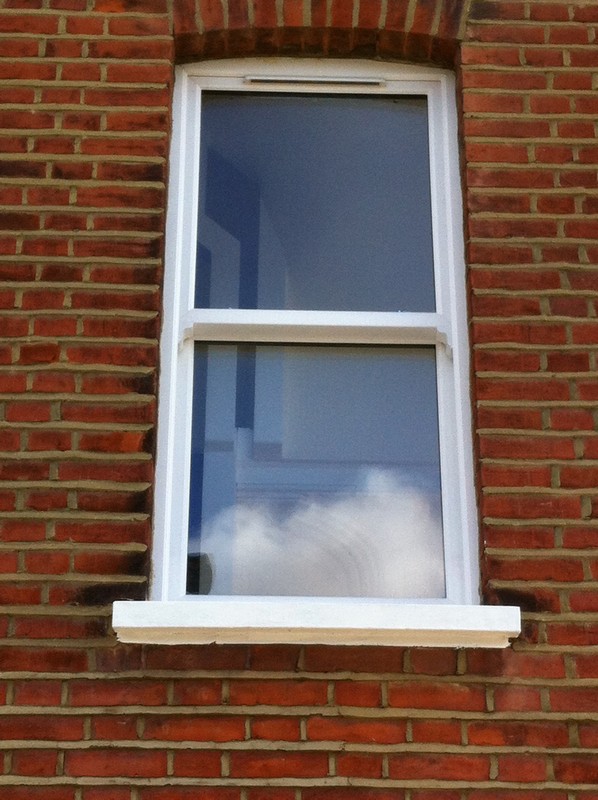 uPVC sash window on Victorian red brick house in New Cross Gate